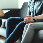 A couple holding hands during a family therapy for addiction session.