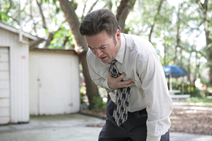 A man suffering from a heart attack outside his home.