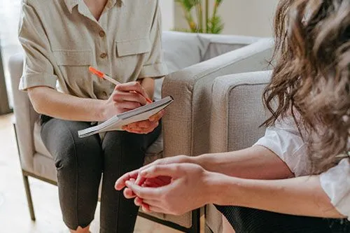 Client sits on chair during intake for dual diagnosis rehab